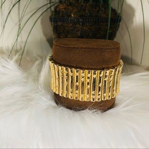 Gold colored bracelet with rhinestones